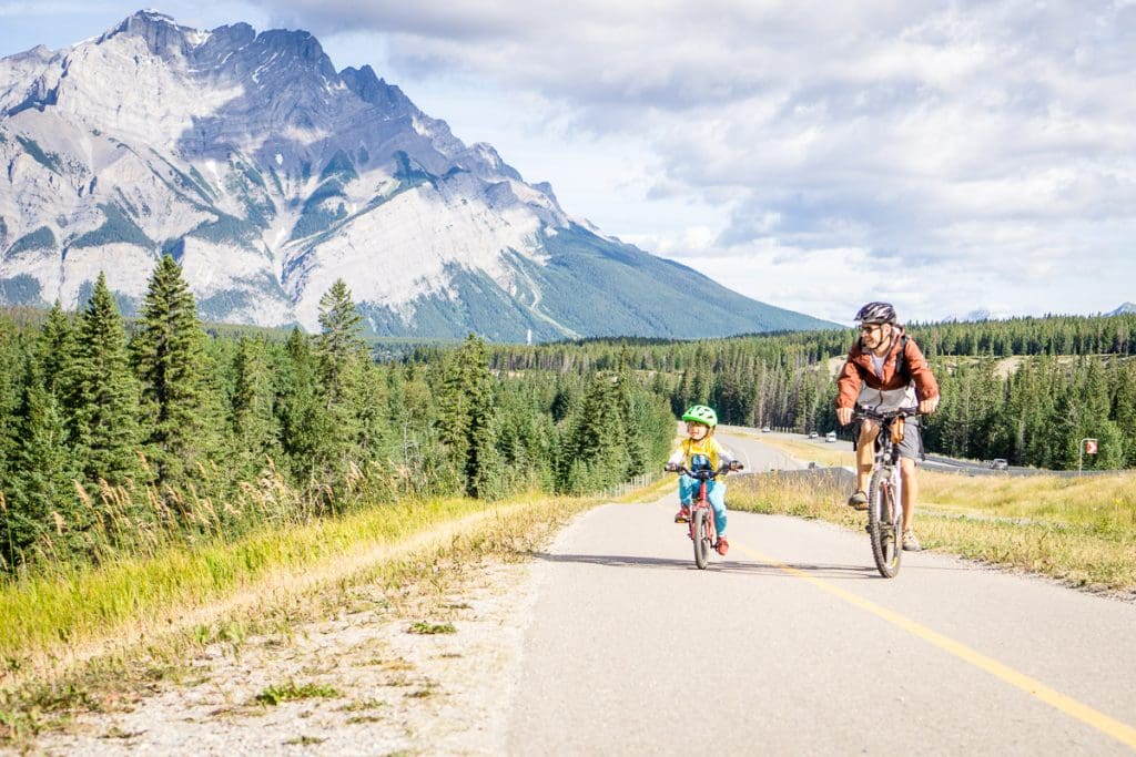 Dan Brewer and child cycling the Legacy Trail in Banff National Park