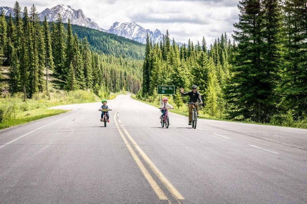 Dan Brewer and two kids riding bikes on Bow Valley Parkway in Banff National Park