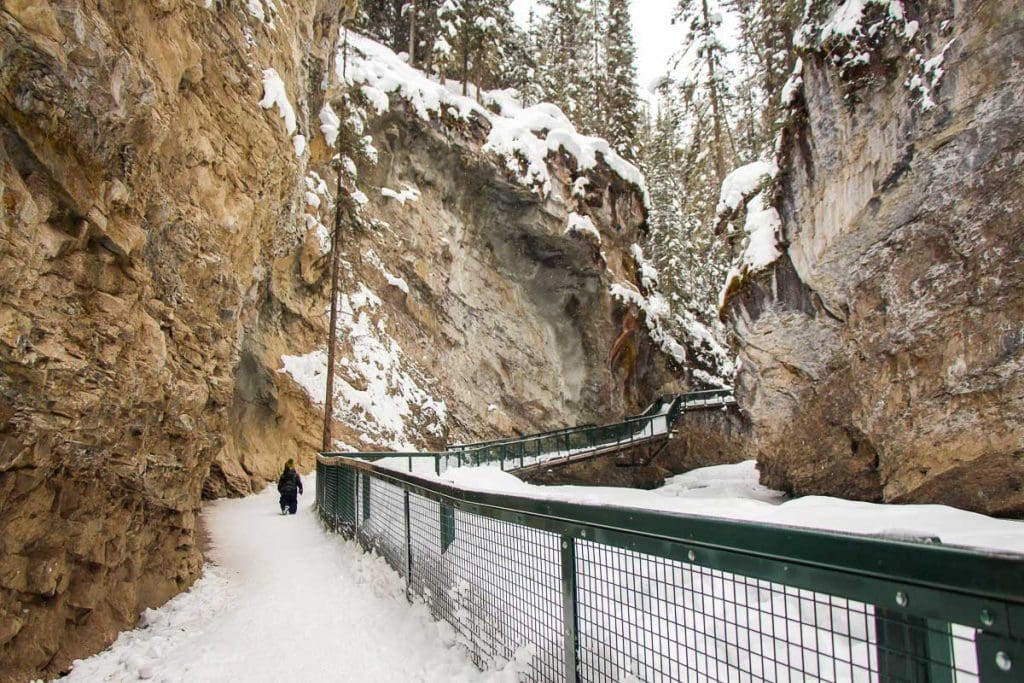 child hiking Johnston Canyon in Banff in winter.
