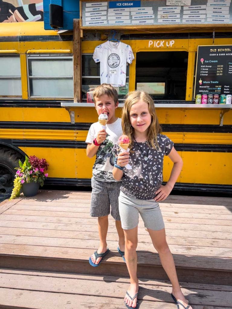 two kids eating ice cream at Ice Cream Bus in Canmore in summer.