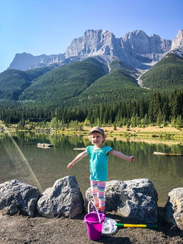 girl standing in front of Quarry Lake in Canmore.