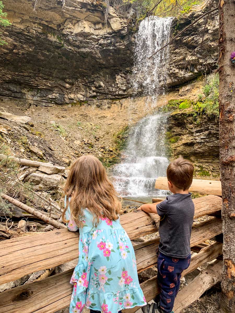 two kids looking at waterfall on Troll Falls hike in Kananaskis.