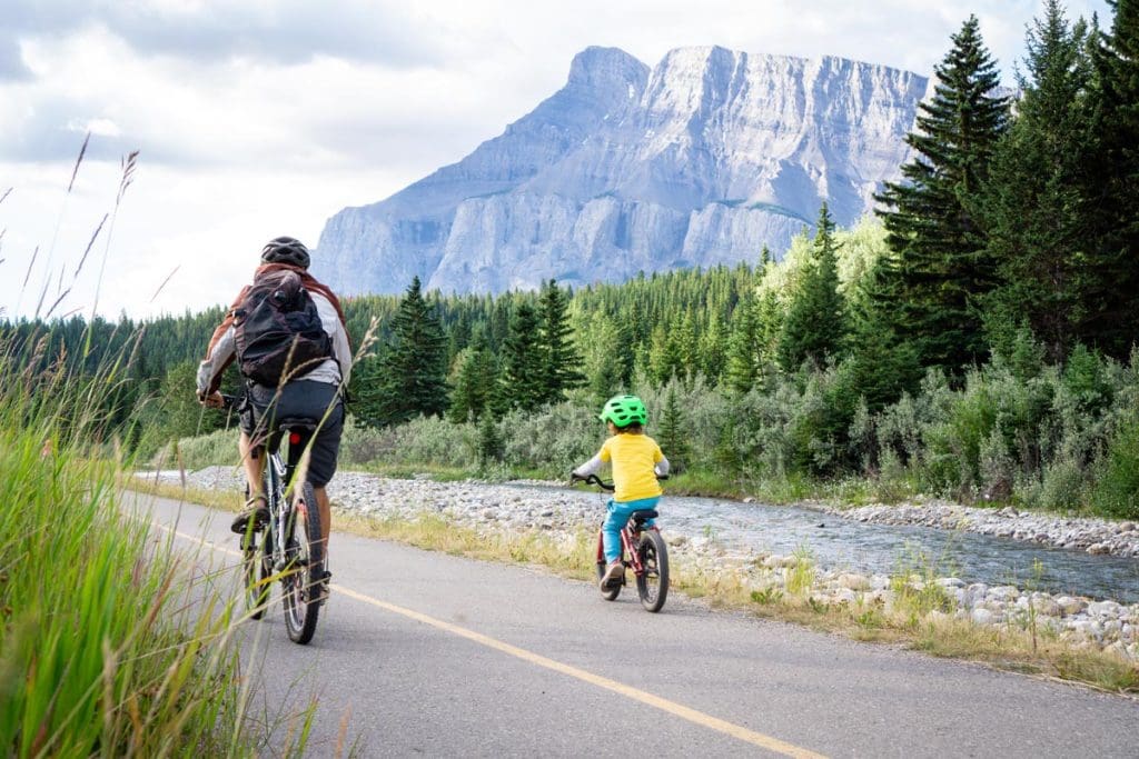 a father and son bike the Legacy trail from Banff to Canmore.