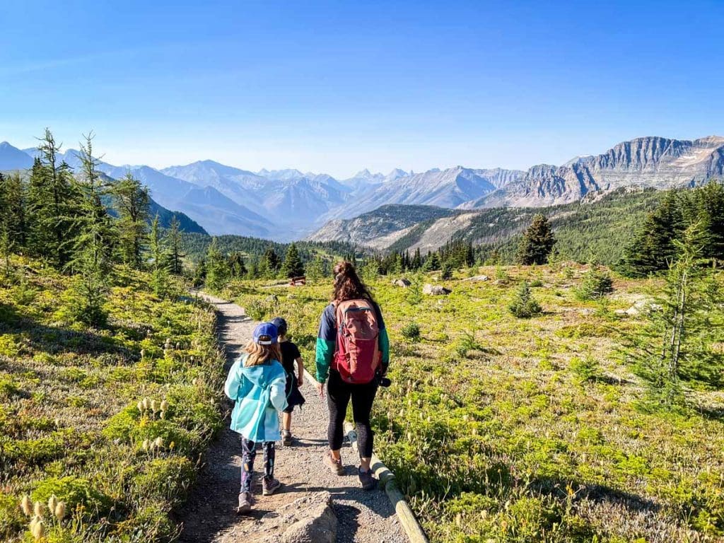 a mother and two kids hike at Sunshine Meadows in Banff National Park.