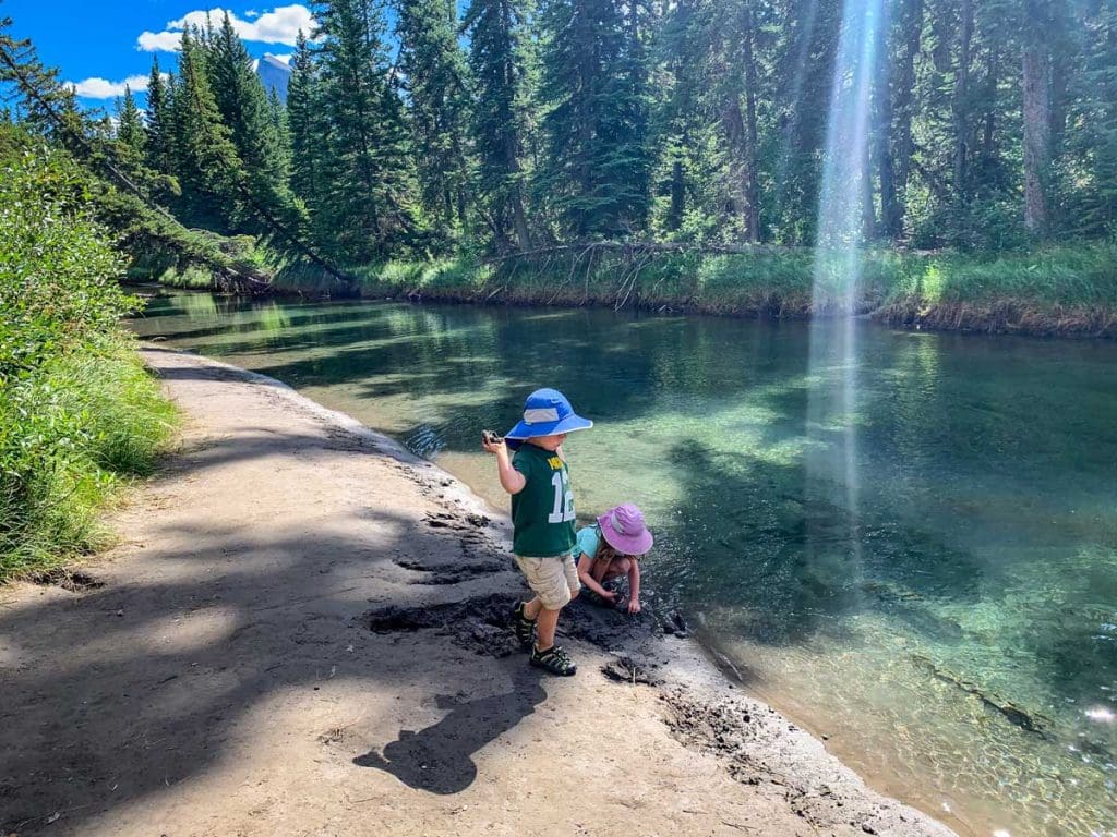 two kids playing in the 40 Mile Creek in Banff.
