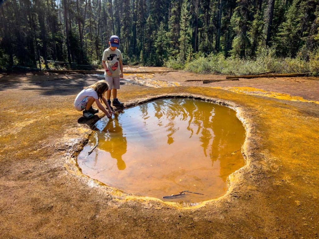 two kids looking at the Paint Pots in Kootenay National Park.