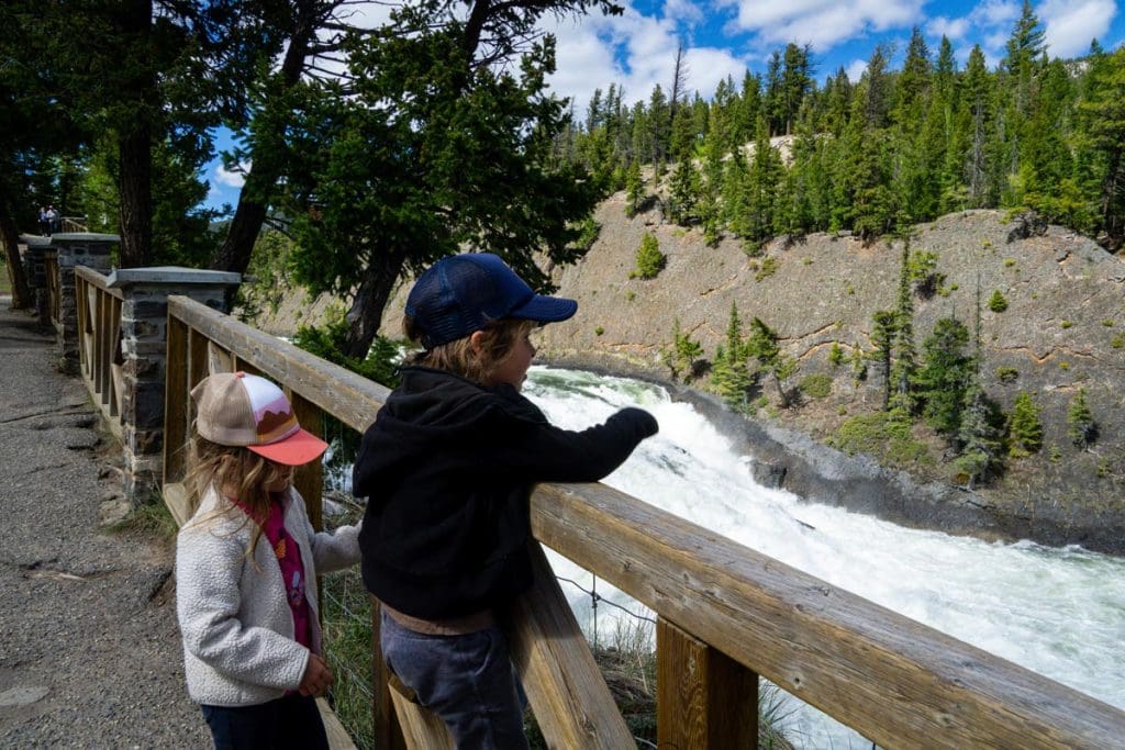 two kids looking at Bow Falls in Banff National Park.