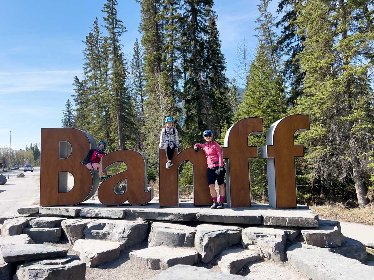 Kids posing on Banff Town Sign.