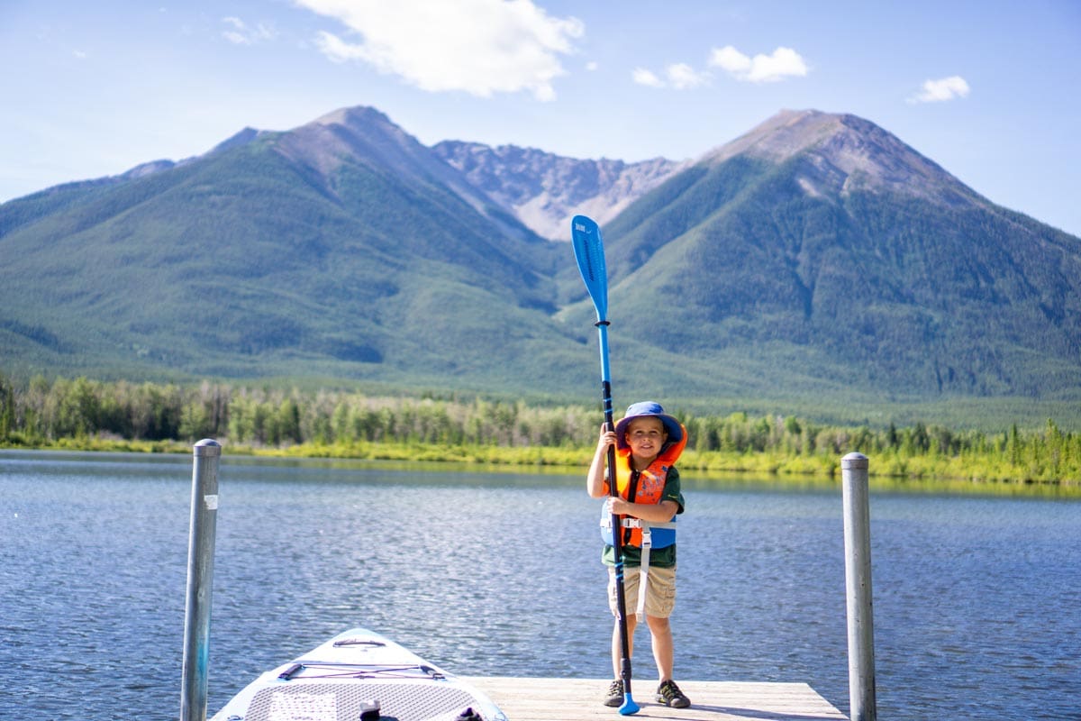 boy standing on dock at Vermilion Lakes in Banff National Park