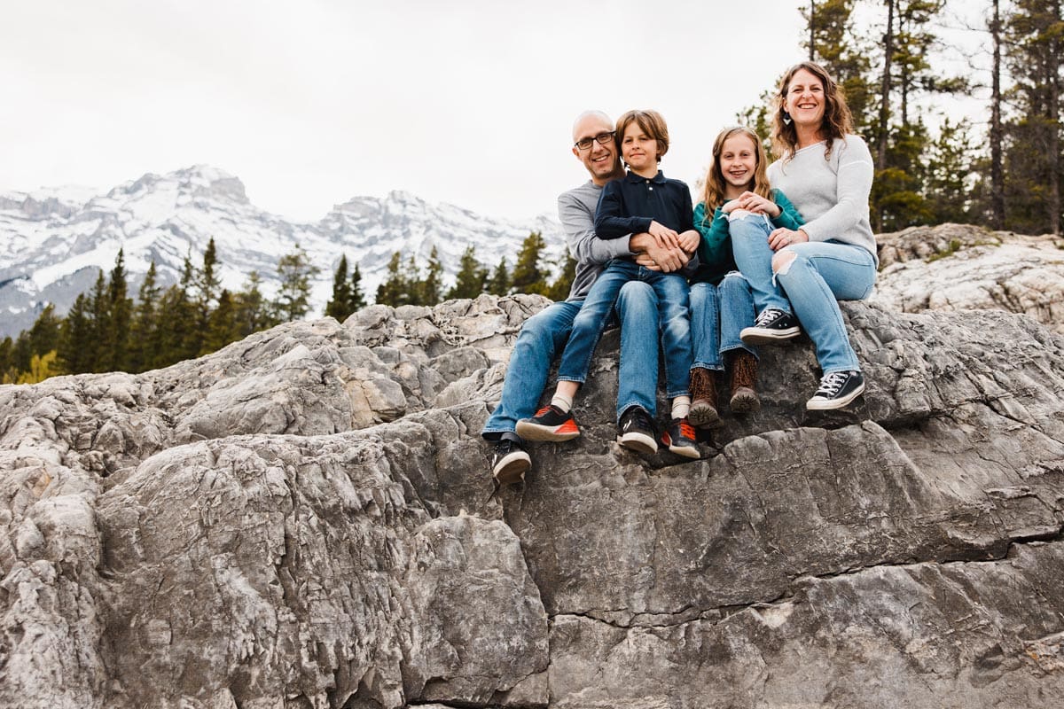 Dan and Celine Brewer, owners of the Travel Banff Canada blog, have a photo shoot with their kids at Lake Minnewanka.