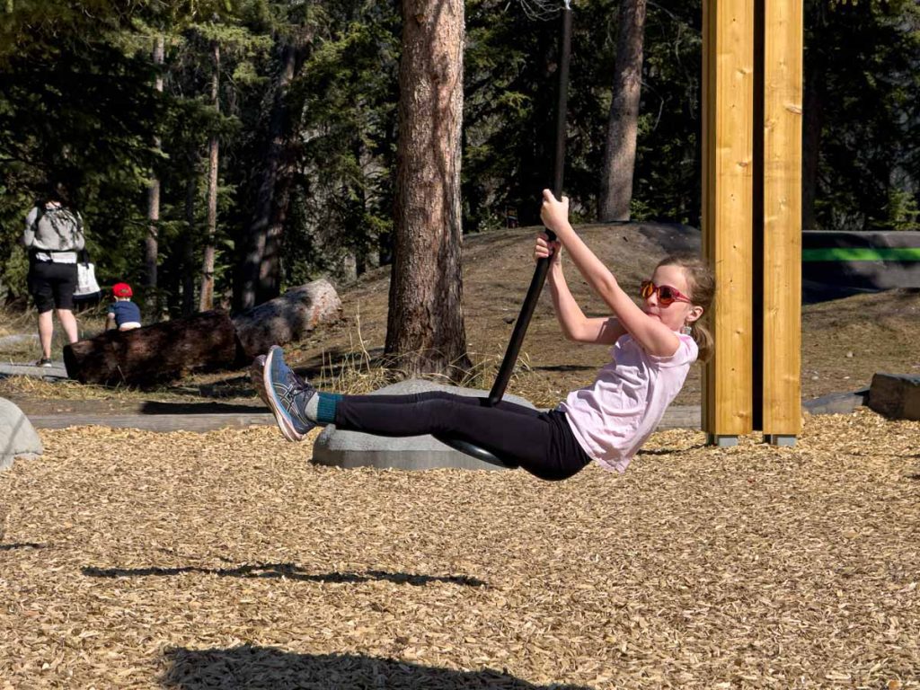 one of the Brewer kids from the Banffwithkids.com blog, enjoys a zip line at Sundance Playground in the Town of Banff.