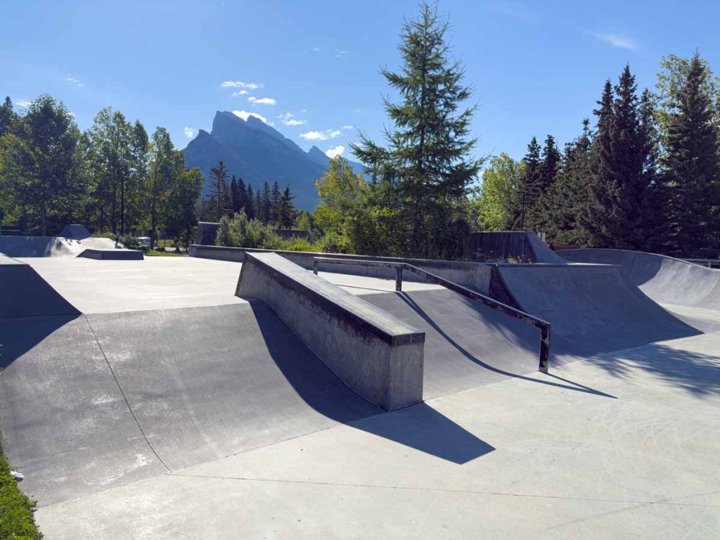 An empty Banff Skatepark with Mt.  Rundle in the background.
