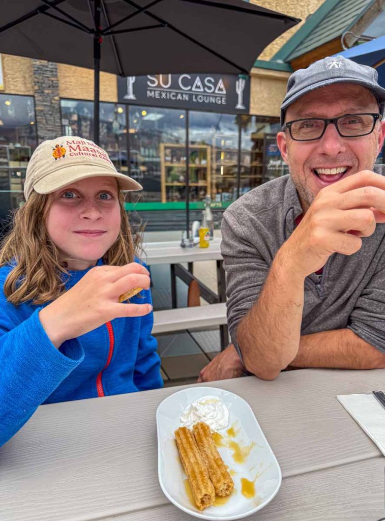 Dan Brewer, owner of Banffwithkids.com, shares churros with his daughter at Su Casa Mexican Lounge during a family trip to Jasper, Canada.