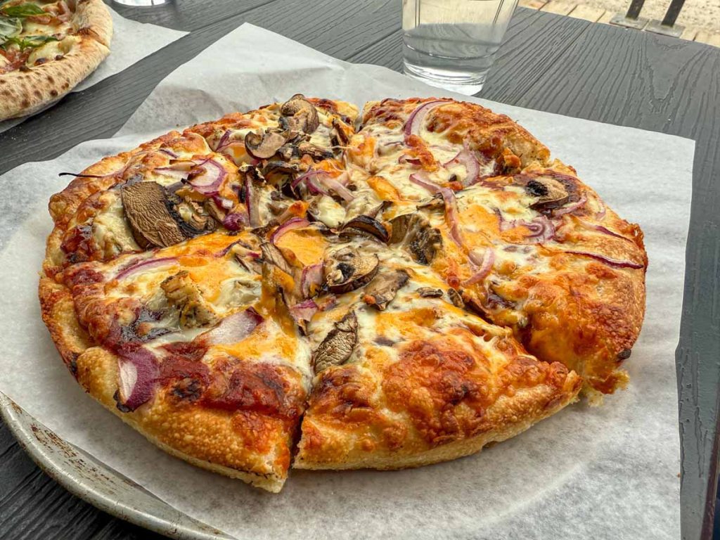 a gooey pizza from Jasper Pizza Company - a kid-friendly restaurant in Jasper, Canada.