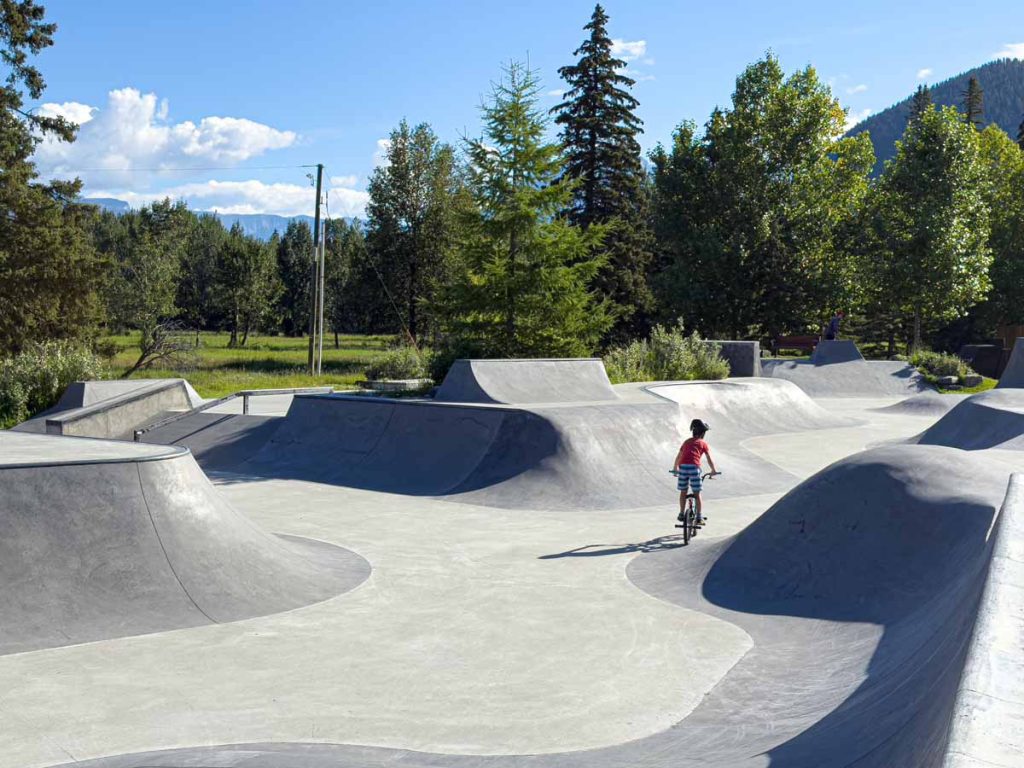 a 10-year old boy rides his BMX bike at the Banff Skatepark in the morning in August.